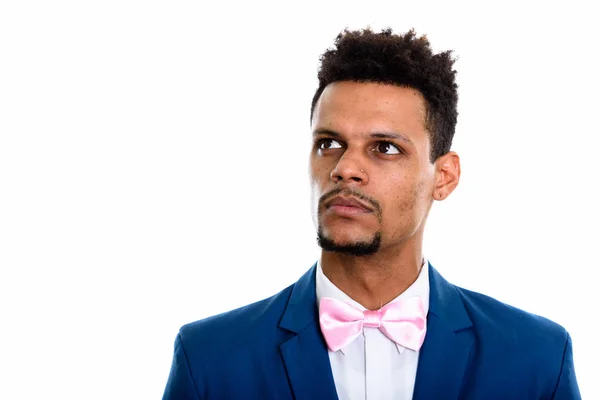 Studio shot of young African businessman thinking while looking — Stock Photo, Image