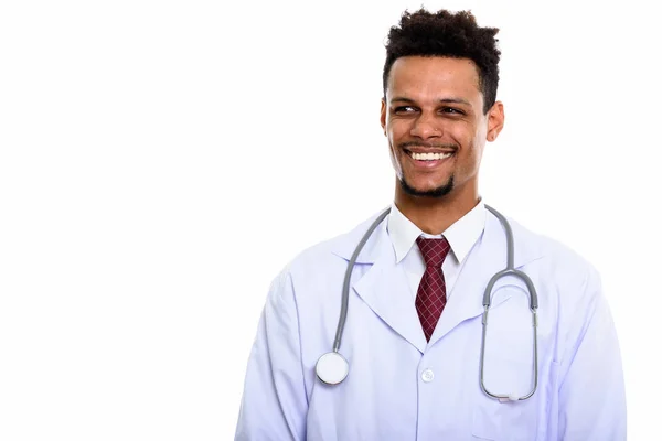 Young happy African man doctor smiling while thinking and lookin — Stock Photo, Image