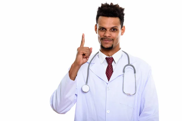 Studio shot of young African man doctor pointing finger up — Stock Photo, Image