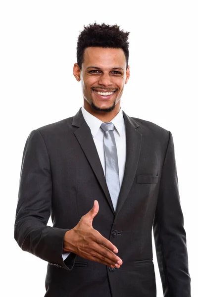 Joven empresario africano feliz sonriendo mientras da apretón de manos — Foto de Stock