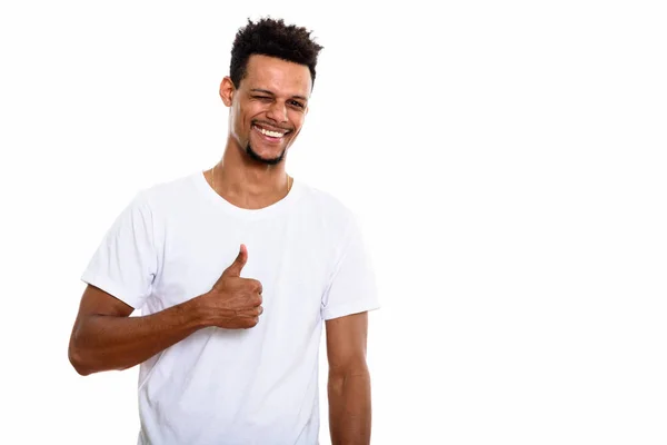 Studio shot of young happy African man smiling while giving thum — Stock Photo, Image