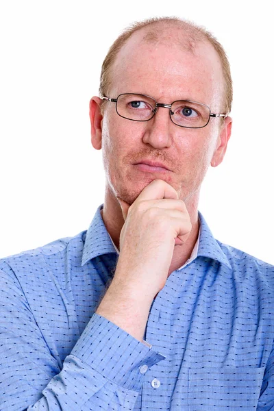 Studio shot of businessman thinking and looking up while wearing — Stock Photo, Image