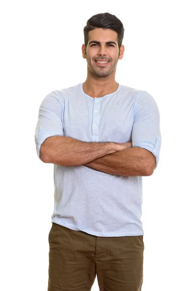 Young happy Persian man smiling with arms crossed — Stock Photo, Image