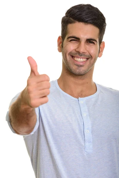 Joven hombre persa feliz sonriendo y dando el pulgar hacia arriba — Foto de Stock