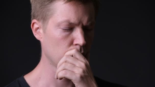 Young handsome man against black background — Stock Video