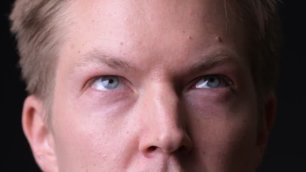 Young handsome man against black background — Stock Video