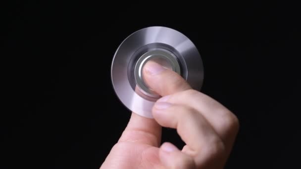 Hand of young man using fidget spinner — Stock Video