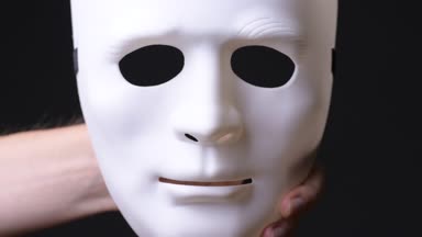 Genç adamın beyaz maske tutan elini