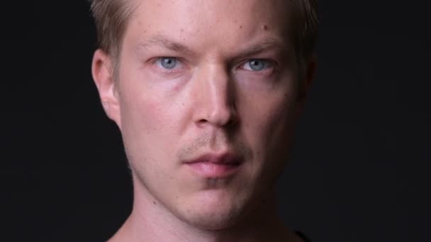 Young handsome man against black background — Stock Video