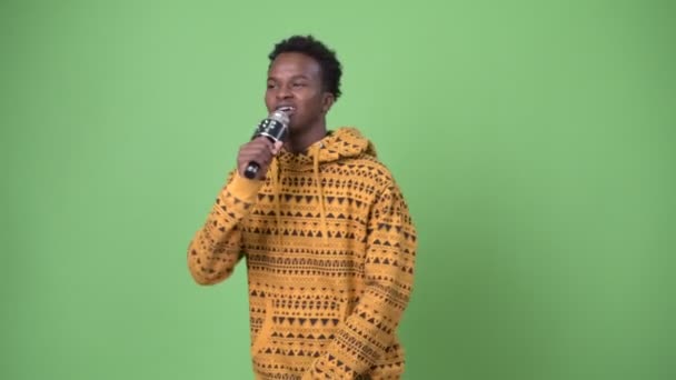 Young African man against green background — Stock Video