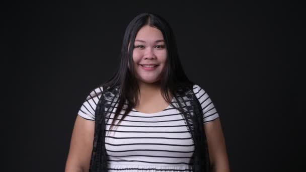 Красивая толстая азиатка на черном фоне — стоковое видео