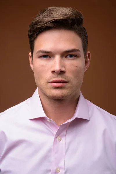 Studio shot of young handsome businessman with pink shirt — Stock Photo, Image