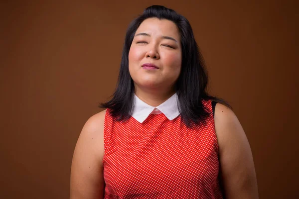 Beautiful overweight Asian woman relaxing with eyes closed — Stock Photo, Image