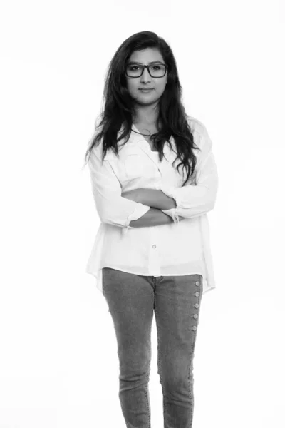 Studio shot of young beautiful Persian woman standing and wearing eyeglasses with arms crossed — Stock Photo, Image