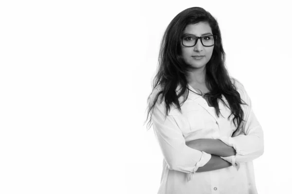 Studio shot of young beautiful Persian woman wearing eyeglasses with arms crossed — ストック写真