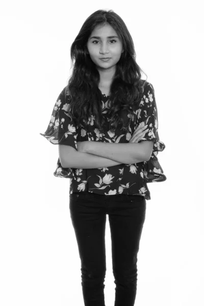 Studio shot of young beautiful Persian woman standing with arms crossed — ストック写真