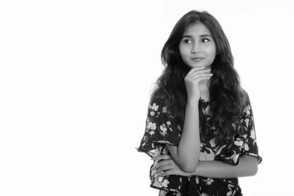 Studio shot of young beautiful Persian woman thinking while looking at distance — ストック写真