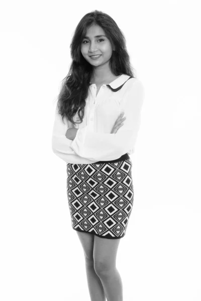 Studio shot of young happy Persian businesswoman smiling and standing with arms crossed — ストック写真