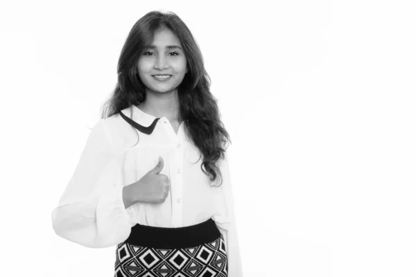Studio shot of young happy Persian businesswoman smiling while giving thumb up — ストック写真