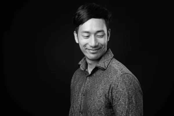 Fiatal jóképű ázsiai üzletember fekete háttér — Stock Fotó