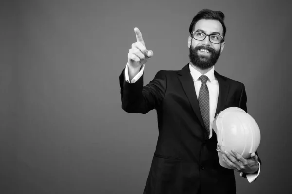 Young handsome bearded Persian businessman against gray background — Stock Photo, Image