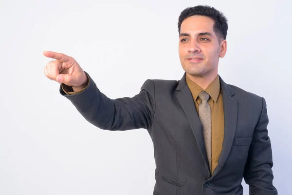 Portret van gelukkige Perzische zakenman in pak regisserend en wijzende vinger — Stockfoto