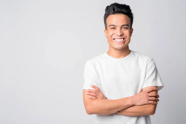 Portrait of happy young Asian man smiling with arms crossed — Stock Photo, Image