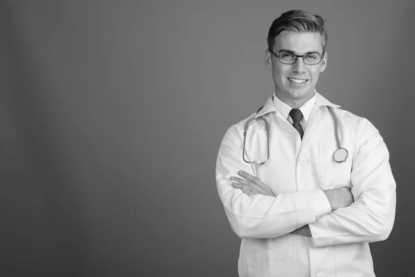 Portrait of young handsome man doctor with eyeglasses in black and white — Stok fotoğraf