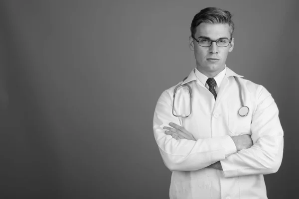 Portrait of young handsome man doctor with eyeglasses in black and white — Zdjęcie stockowe