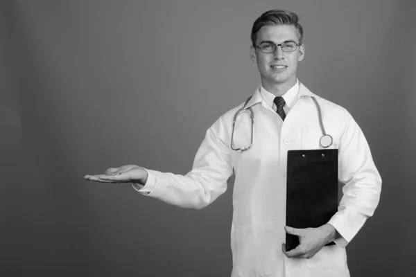 Portrait of young handsome man doctor with eyeglasses in black and white — Stok fotoğraf