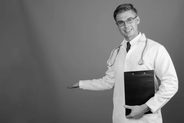 Portrait of young handsome man doctor with eyeglasses in black and white — Zdjęcie stockowe