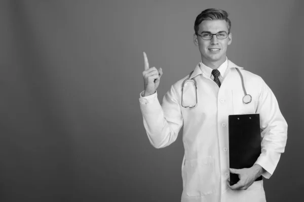 Portrait of young handsome man doctor with eyeglasses in black and white — ストック写真