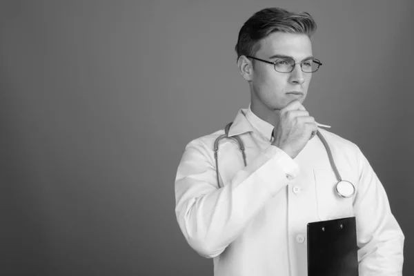 Portrait of young handsome man doctor with eyeglasses in black and white — Zdjęcie stockowe