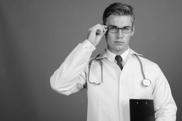 Portrait of young handsome man doctor with eyeglasses in black and white — ストック写真