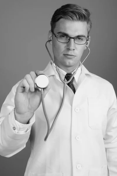 Portrait of young handsome man doctor with eyeglasses in black and white — Stock Fotó