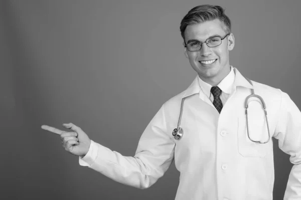 Portrait of young handsome man doctor with eyeglasses in black and white — Stock Fotó