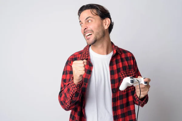 Portrait of stressed Hispanic hipster man playing games and looking angry — ストック写真