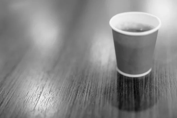 Hot Coffee In Paper Cup Placed On Wooden Table In Black and White — Stok Foto