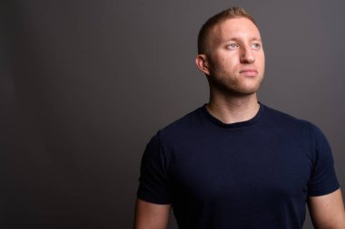 Studio shot of man with blond hair against gray background