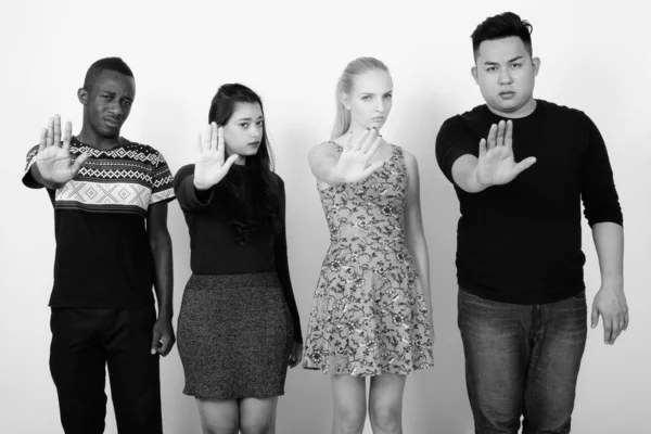 Studio foto di diversi gruppi di amici multietnici che mostrano segno di stop mano insieme — Foto Stock