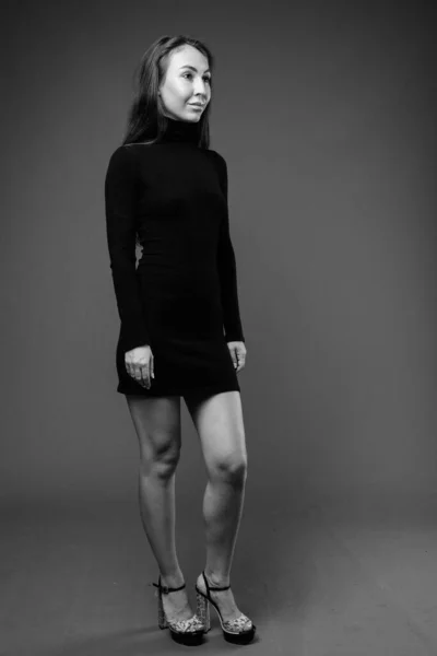 Studio shot of young beautiful businesswoman in black and white — Stock Photo, Image