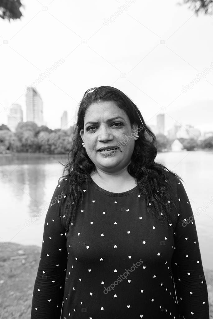 Portrait of mature Indian woman relaxing at the park