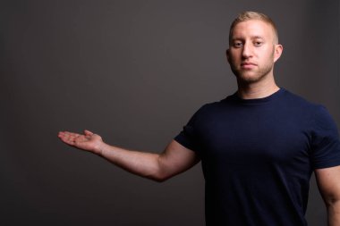 Man with blond hair against gray background