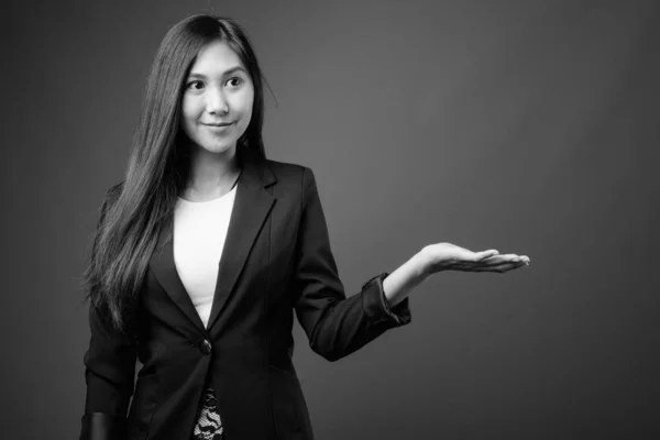 Young beautiful Asian businesswoman in black and white — Stock Photo, Image