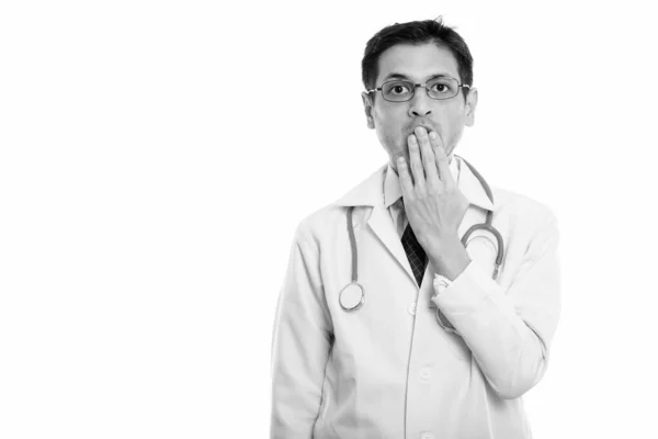 Studio shot de jeune homme médecin portant des lunettes tout en regardant choqué — Photo