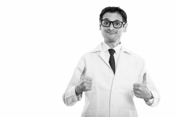 Studio shot of young man doctor giving thumbs up — Stock Photo, Image