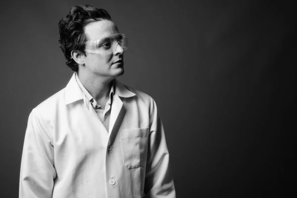 Italian man doctor wearing protective glasses in black and white