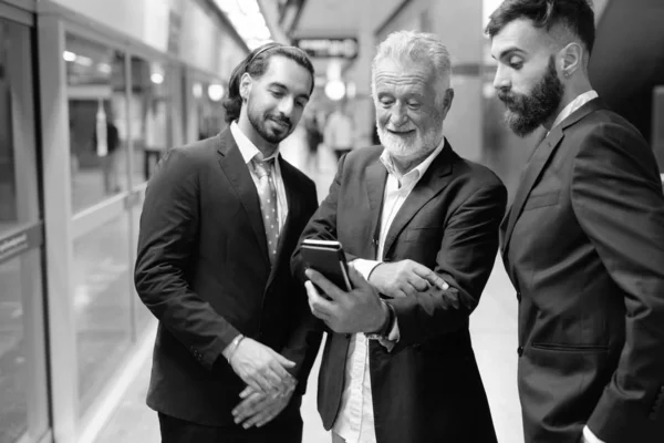 Multi ethnic bearded businessmen together around the city