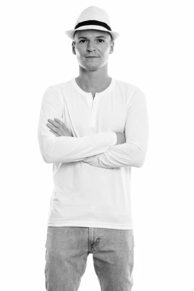 Studio shot of young handsome man standing with arms crossed — Stock Photo, Image