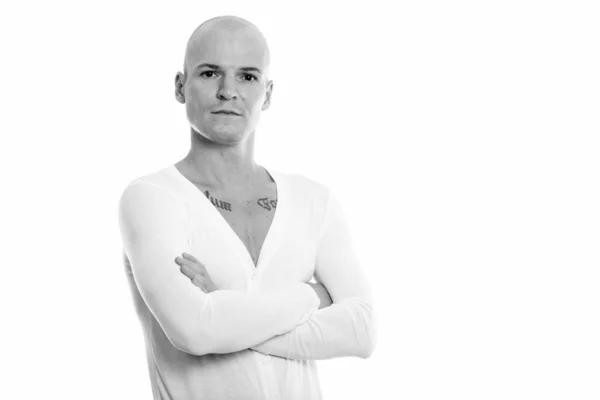 Studio shot of young handsome bald man with arms crossed — Stock Photo, Image